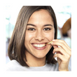 Load image into Gallery viewer, TePe EasyPick™ Orange being used for interdental cleaning.