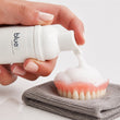Load image into Gallery viewer, Bluem oral foam being applied directly to a denture for cleaning
