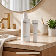 Load image into Gallery viewer, Oxygen Fluid bottle shown with Oral Gel, sold separately, in a warm bathroom setting.
