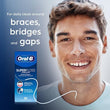 Load image into Gallery viewer, Smiling man beside Oral-B Superfloss Threader packaging, designed for daily cleaning around braces, bridges and gaps.
