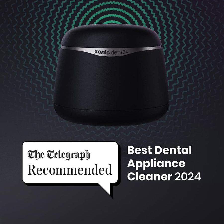 Black Sonic Pro dental appliance cleaner with 'Sonic Dental' branding on a dark background, featuring 'The Telegraph Recommended Best Dental Appliance Cleaner 2024' text.