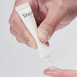 Load image into Gallery viewer, Hand applying blue®m oral gel 15ml directly onto fingertip
