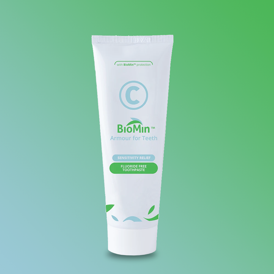 BioMin C Toothpaste, 75ml tube on green gradient background, fluoride-free, sensitivity relief.